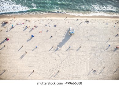 Santa Monica Beach, Drone View - People Sunbathing On The Beach And Swimming In The Ocean