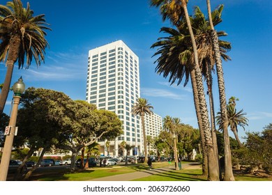 Santa Monica, CA - Aug 2, 2018: 100 Wilshire white building in Santa Monica, view from Palisades park with palms in sunny day