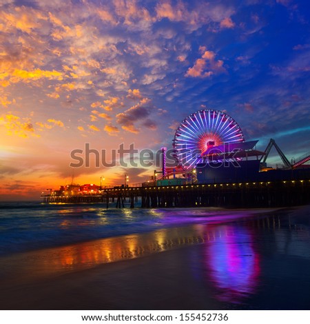 Santa Monica California sunset on Pier Ferris wheel and reflection on beach wet sand