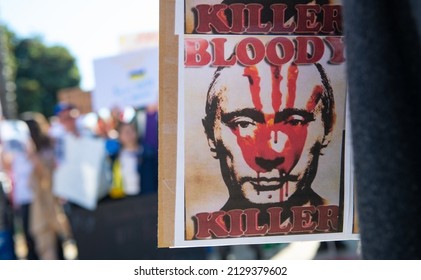 Santa Monica, California, USA - February 25, 2022: Blood on Putins face. The killer. Stop Putin, stop war. Stand with Ukraine. Russia war against Ukraine, aggressive invasion