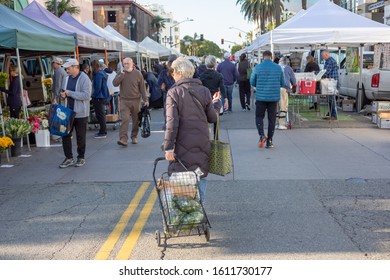 Santa Monica, California/United States - 12/28/2019: A Woman Pulls A Shopping Cart As She Shops At The Santa Monica Farmers Market.