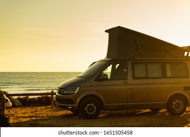 SANTA POLA, SPAIN - FEBRUARY 19, 2019: Camper California Volkswagen van with tent on roof camping on coast of seaside spanish Santa Pola city, Costa Blanca