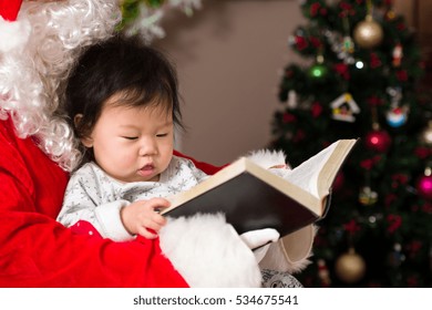 Santa Reading Story To Baby Girl