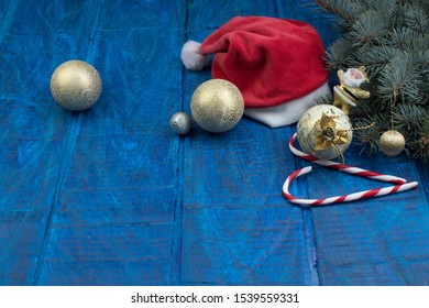 Santa red hat, Gift boxes and colorful present for christmas on blue background. Top view with copy space.
