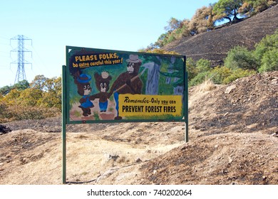 Santa Rosa, CA - October 22, 2017: Sign Along Roadside Calistoga Rd, REMEMBER, ONLY YOU CAN PREVENT FOREST FIRES In The Middle Of Burned Out Landscape From The Recent Wild Fires In Sonoma County