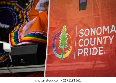 SANTA ROSA, CALIFORNIA - JUNE 4, 2022: Photo Of A Sonoma County Pride Sign On The Stage With A Dancer’s Colorful Skirt In The Background At The Festival A In Old Courthouse Square.