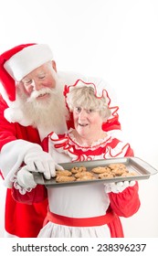 Santa Steals A Warm Cookie From Mrs Claus Tray.