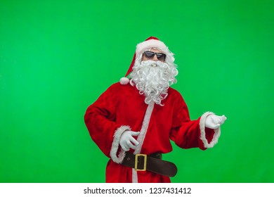 Santa in sunglasses playing imaginary guitar at christmas party on green background, Chroma key. - Powered by Shutterstock