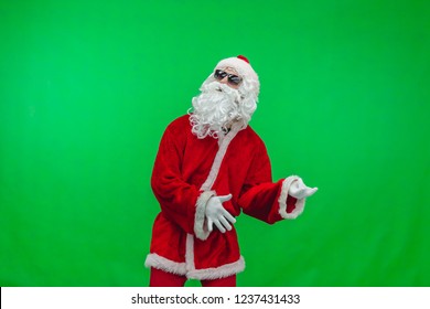 Santa in sunglasses playing imaginary guitar at christmas party on green background, Chroma key. - Powered by Shutterstock