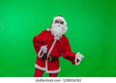 Santa in sunglasses playing imaginary guitar at christmas party on green background, Chroma key - Powered by Shutterstock