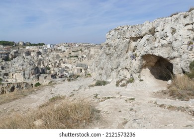 Sant'Agnese rupestrian church in Murgia Materana Park with an arched entrance carved into the rock introducing in the cave - Shutterstock ID 2121573236