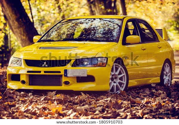 Santander,\
Cantabria / Spain, 11-18-2018: Mitsubishi Lancer Evolution 9, shot\
in a mountain road full of autumn\
leaves