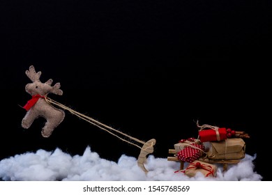 
A Santa's Reindeer Puppet Flying A Small Sleigh Full Of Christmas Presents