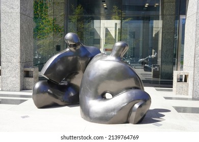 Santiago - Chile - February 10, 2022: modern black statues representing two fat women sit back to back on the ground (public square in front of Costanera center).
