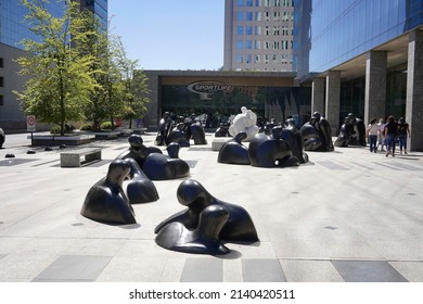 Santiago - Chile - February 10, 2022: street art in front of Costanera center, sculptures representing black and white heads and busts kissings.