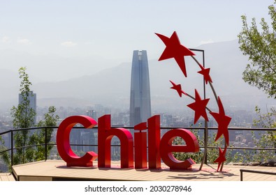 Santiago, Chile - Jan 7, 2021: Chile red sign in San Cristobal mountain view point with Costanera Center building behind logo. Sunny day in urban area with iconic landmark