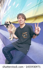 Santiago, Chile, July 2019: Chilean Boy With His Clever Friend - A Cute Dog -  Enjoying Paseo Bandera Touristic Place In A Beautiful Inviting Hot Weather Sunday Morning In Santiago Capital