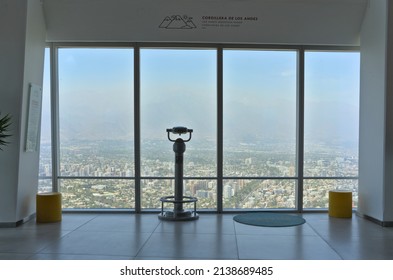 Santiago - Chile - March 05, 2022 - Binoculars and sits for tourists at the top of the Costanera center tower and view on Santiago during foggy morning in summer.