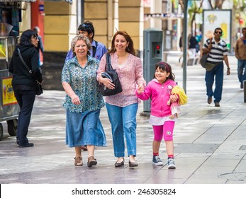 SANTIAGO, CHILE - NOV 1, 2014:  Unidentified Chilean Family Walks In Santiago. Chilean People Are Mainly Of Mixed Spanish And Indigenous Descent