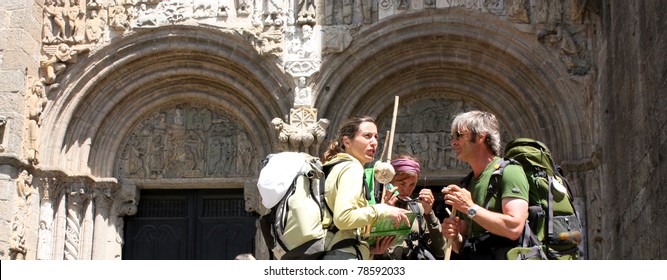 SANTIAGO DE COMPOSTELA, SPAIN - MAY 30: Pilgrims on the Camino de Santiago in the door Platerias after reaching Santiago de Compostela on May 30, 2009, in Santiago, Spain. Xacobeo year.