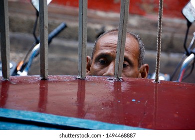 Santiago De Cuba / Cuba: May 5, 2016: A Cuban Man Peers Through Window Bars As Travelers Attend A Local Dance Performance In The Town Of Santiago De Cuba 