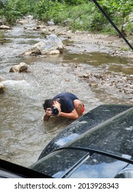 Santiago Nuevo Leon, Mexico. July 15, 2021. Teen Boy Photographer Taking A Picture To An All Road Vehicle Outdoors. 