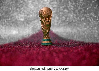 Vitória, Espírito Santo, Brazil - February 03, 2022 -  Copy of world cup trophy on background red, white and silver, qatar flag's color