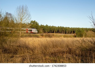 Santon Downham And Brandon, West Suffolk, England, United Kingdom - March 21 2020: Greater Anglia Fast Train In Fields