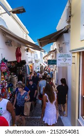 Santorini, Greece - August 6, 2021: Tourists crowd through the narrow streets of Santorini. Crowds of people visit the small island in the cyclades archipelago every year. Mass tourism through cruises