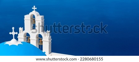 Santorini, Greece panoramic copy space banner with white Greek orthodox church and blue sea in Oia