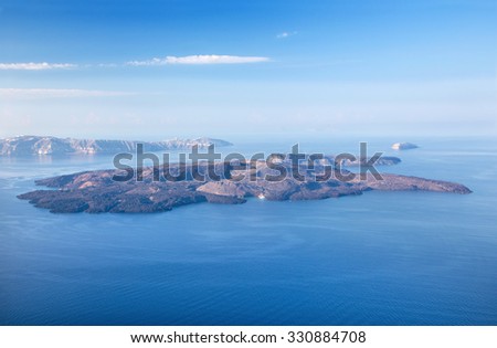 Santorini - The islands Nea Kameni and Palea Kameni and the south part of the Island in background.