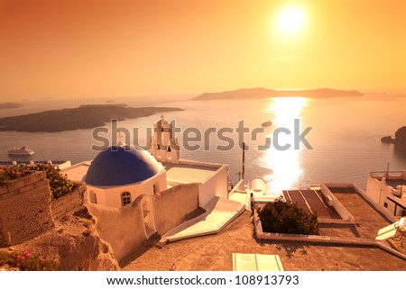 Santorini with sunset over Church in Fira town, Greece