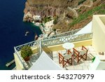 SANTORINI (THERA), CYCLADES, GREECE - Relaxing sea view from Fira towards a lovely terrace and into Ormos Firon harbour with traditional excursion boats in the bay.