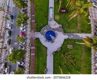 Santos, São Paulo, Brazil - November 15, 2021: Families Enjoying The Late Afternoon At Alderman Luiz La Scala Square. Fisherman's Monument, Fountain, Bike Path And Waterfront Gardens Seen From Above.