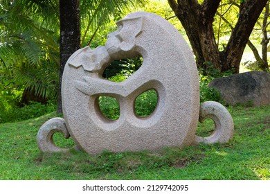 Sanya City, Hainan Island, China - September 29, 2017: Stone Sculpture Of A Couple Kissing And Hugging Monkeys In Green Tropical Garden.