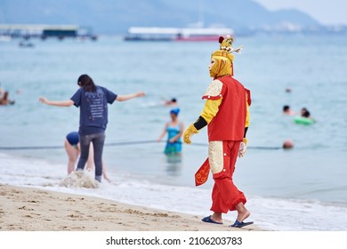 SANYA HAINAN, CHINA  - DECEMBER 19 2018: Chinese Animator In The Bright Monkey King Suit Walks On The Beach 