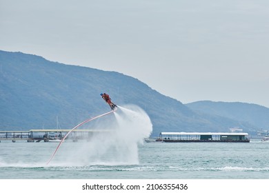 SANYA HAINAN, CHINA  - DECEMBER 19 2018: Flyboarding Tourists With A Water Jetpack On The City Beach 