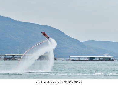 SANYA HAINAN, CHINA  - DECEMBER 19 2018: Flyboarding Tourists With A Water Jetpack On The City Beach 