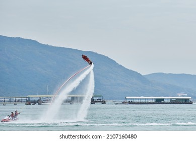 SANYA HAINAN, CHINA  - DECEMBER 19 2018: Flyboarding Tourists With A Water Jetpack On The City Beach 