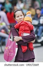 SANYA-JAN. 16, 2008. Chinese Mother With Her Child. Chinese Government Plans To Relax The Its One Child Policy: Couples In Which Either Member Is An Only Child Will Be Permitted To Have Two Children.