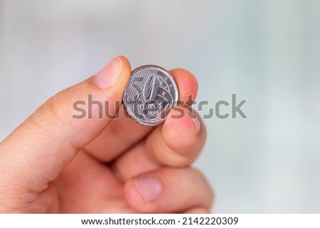 
Sao Paulo, Brazil. APRIL 3, 2022: Brazilian 50 cents coin in the palm of a person. Hand holding a 50 real cents coin. Real is the currency system of the Brazilian Government.

