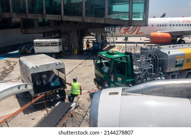 Sao Paulo, Brazil, February 25, 2022. Petrobras Aviation Tanker Truck With Fuel And Workers Loading Luggage In The Aircraft Yard At Congonhas Airport In São Paulo