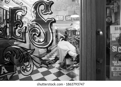 Sao Paulo, Brazil. July 03, 2020. Man Shaving In A Traditional Barber Shop In Sao Paulo, During The Coronavirus Pandemic Photographed In Black And White.