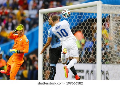 SAO PAULO, BRAZIL - June 19, 2014: Martin Caceres of Uruguay and Wayne Rooney of England compete for the ball during the game between Uruguay and England at Arena Corinthians. No Use in Brazil.