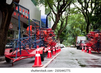 SAO PAULO, BRAZIL - May 04, 2018: A Red Bikes On Street Trailers Placed Next To A Sidewalk In The Street Of Sao Paolo, Brazil