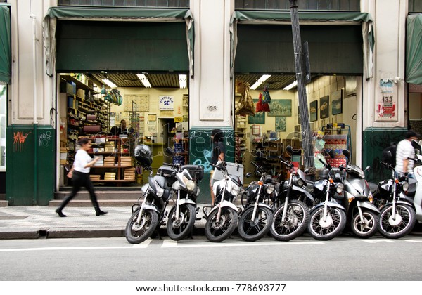 SAO PAULO, BRAZIL - OCT 27th 2017: \
Stationary store with lots of parking motorcycles in front at the\
heart of the city of Sao Paulo, downtown\
area.