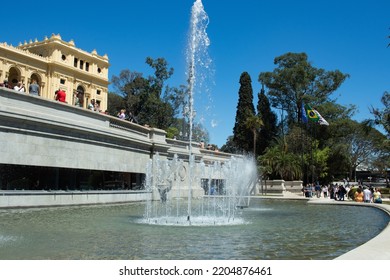 SAO PAULO, SAO PAULO, BRAZIL - SEPTEMBER 18, 2022: Spouting Fountain In The  Independence Park (Parque Da Independência) After Restoration And Modernization, Flags Of Brazil, City Of São Paulo And USP