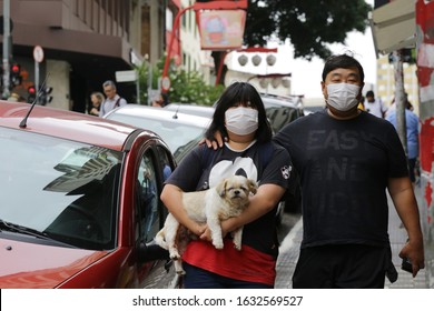 Sao Paulo, SP / Brazil - February 1, 2020: People wears masks as they walk in Liberdade area to protect from coronavirus, COVID-19, that has sickened thousands of people in China and other countries.