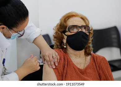 Sao Paulo, SP, Brazil - February 5, 2021: A Nurse Gives A Shot Of COVID-19 CoronaVac Vaccine To An Elderly Woman During A Priority Vaccination Program For People With More Than 90 Years Old.