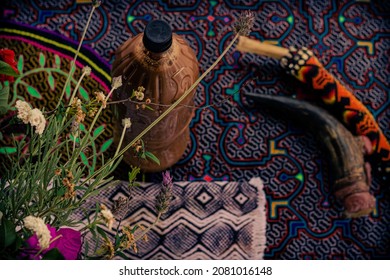 Sao Paulo, SP, Brazil - October 25 2021: Ceremony altar with shipibo fabric, flowers, bottle with Ayahuasca, bone tipi for snuff application.